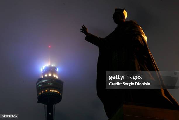 Statue of Cardinal Moran at St Mary's Cathedral is seen silhouetted against the back drop of Sydney Tower as lights are switched off for Earth Hour...