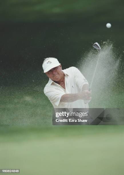 Arnold Palmer of the United States keeps his eye on the ball as he hits out of the bunker during the Cadillac NFL Golf Classic tournament on 3 June...