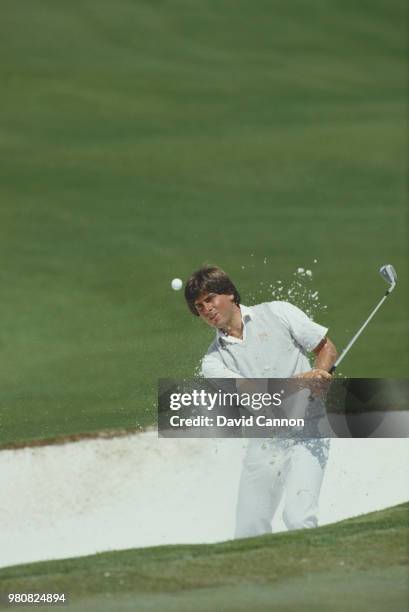Fred Couples of the United States chips out of the sand bunker on 11 April 1985 during the US Masters Golf Tournament at the Augusta National Golf...