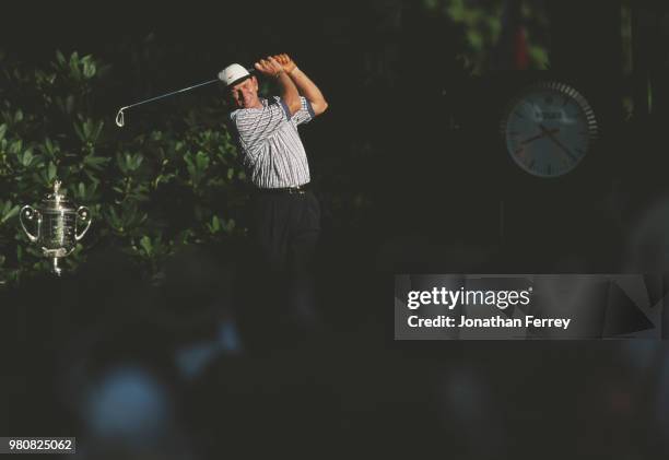 Nick Price of South Africa drives off the tee beside the Professional Golfers' Association trophy during the 80th PGA Championship golf tournament on...