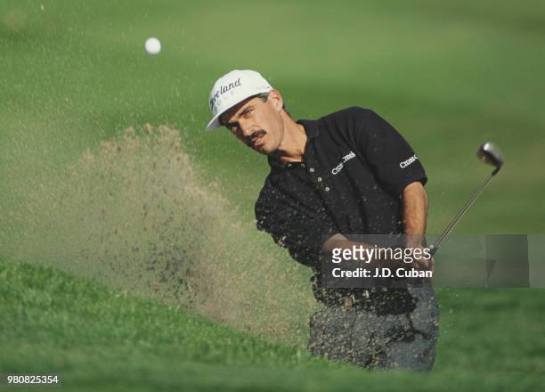 Corey Pavin of the United States keeps his eye on the ball as he hits out of the bunker during the Mercedes Championships golf tournament on 5...