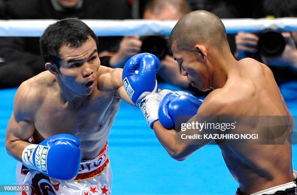 Thailand's challenger Pongsaklek Wonjogkam hits his left on Japanese champion Koki Kameda during their WBC flyweight title match at Ariake Colosseum...