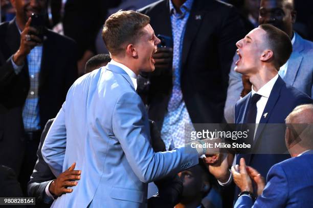 Moritz Wagner reacts with his brother in the stands after being drafted 25th overall by the Los Angeles Lakers during the 2018 NBA Draft at the...