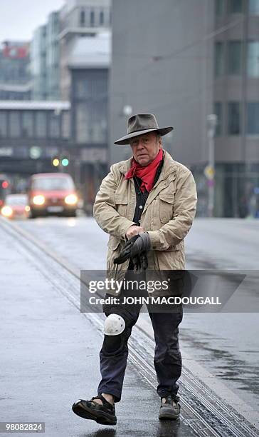 German artist Gunter Demnig arrives to lay "stolpersteine" or stumbling stones in Berlin's Friedrichstrasse March 27, 2010. The stones, topped with...