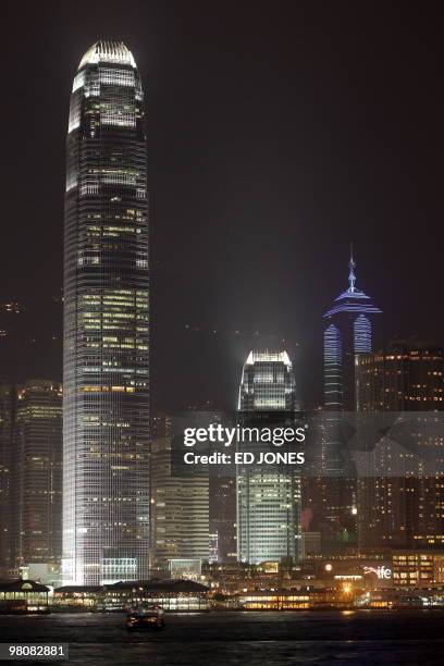 The International Finance Centre tower stands illuminated on Hong Kong's Victoria harbour waterfront prior to Earth Hour on March 27, 2010. Hong...