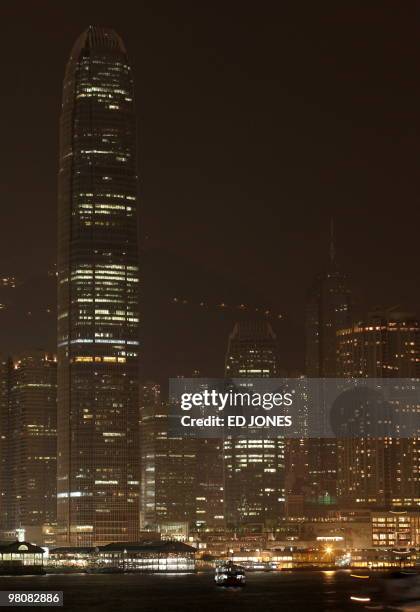 The International Finance Centre tower stands with its lights dimmed on Hong Kong's Victoria harbour waterfront during Earth Hour on March 27, 2010....