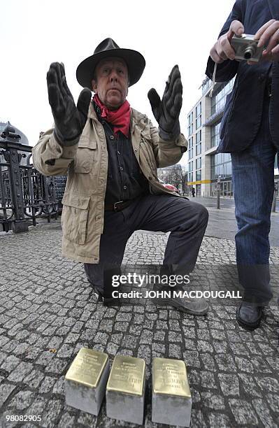 German artist Gunter Demnig prepares to lay "stolpersteine" or stumbling stones in Berlin's Friedrichstrasse March 27, 2010. The stones, topped with...