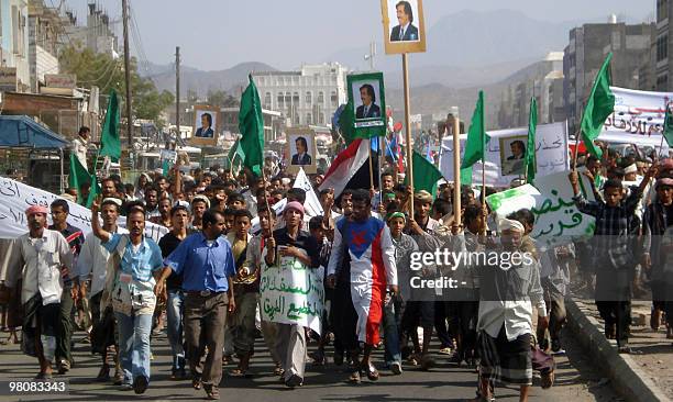 Southern Yemenis hold pictures of former South Yemen leader Ali Salem al-Beidh during a rally in Lahj province, 370 kms south of Sanaa, on March 27,...