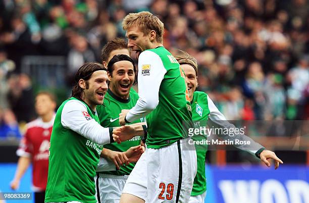 Per Mertesacker of Bremen celebrate with his team mates after scoring his team's opening goal during the Bundesliga match between Werder Bremen and...