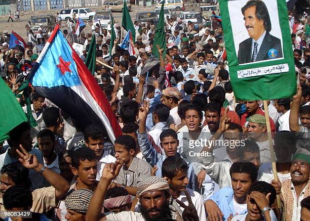 Southern Yemenis wave the flag of former South Yemen and hold a picture of its former leader Ali Salem al-Beidh during a rally in Lahj province, 370...