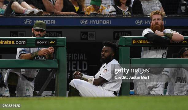 Josh Harrison of the Pittsburgh Pirates looks on from the dugout with Sean Rodriguez and Colin Moran during the game against the Arizona Diamondbacks...