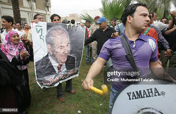 Supporters of former Iraqi Prime Minister Iyad Allawi celebrate the day after the announcement of the election results which showed that a coalition...