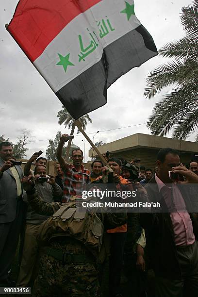 Supporters of former Iraqi Prime Minister Iyad Allawi celebrate the day after the announcement of the election results which showed that a coalition...