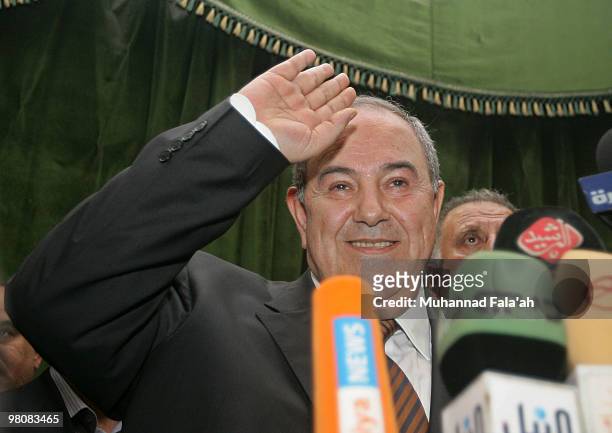 Former Iraqi Prime Minister Iyad Allawi waves for his supporters as they celebrate the day after the announcement of the election results which...