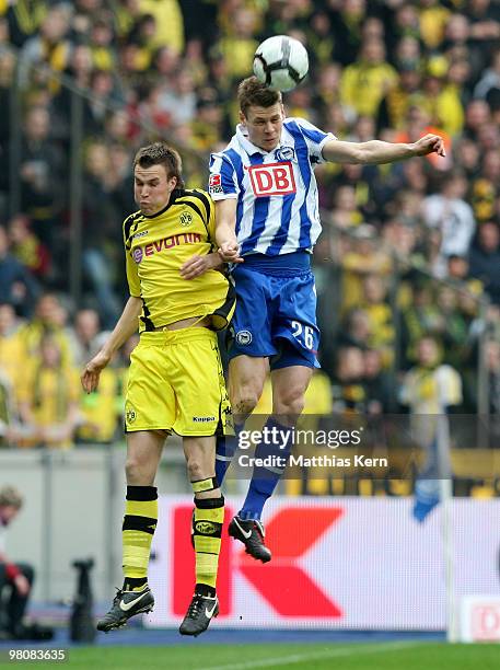 Lukasz Piszczek of Berlin and Kevin Großkreutz of Dortmund jump for a header during the Bundesliga match between Hertha BSC Berlin and Borussia...