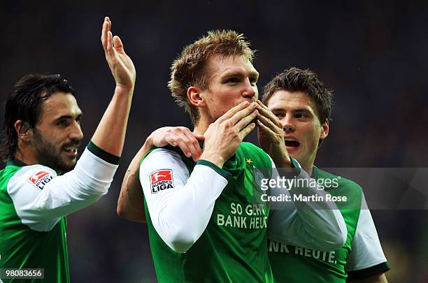 Per Mertesacker of Bremen celebrates with his team mates after scoring his team's opening goal during the Bundesliga match between Werder Bremen and...