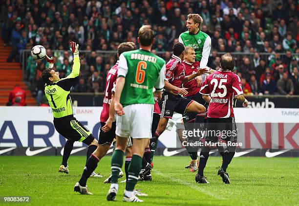 Per Mertesacker of Bremen scores his team's second goal during the Bundesliga match between Werder Bremen and 1. FC Nuernberg at the Weser Stadium on...