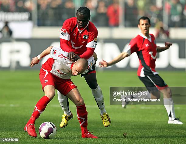 Miso Brecko of Koeln vie for the ball with Didier Ya Konan of Hannover during the Bundesliga match between Hannover 96 and 1. FC Koeln at AWD Arena...