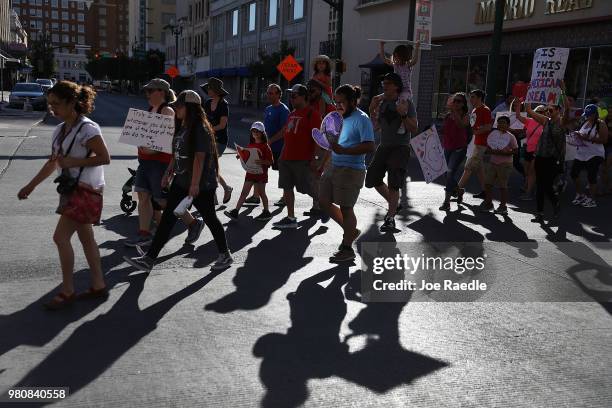 Protesters walk though the streets as they protest against the Trump administration's immigration policies on June 21, 2018 in El Paso, Texas. Before...