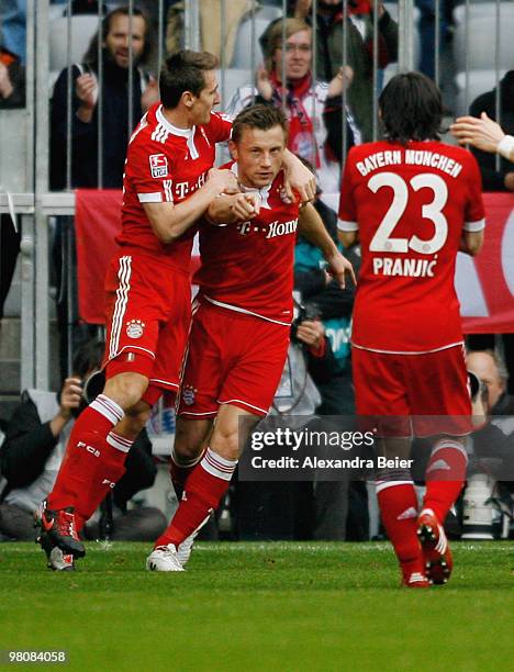 Ivica Olic of Bayern Muenchen celebrates after scoring his team's first goal with team mates Miroslav Klose and Danijel Pranjic during the Bundesliga...