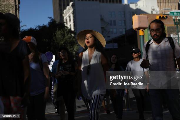 Protesters walk though the streets as they protest against the Trump administration's immigration policies on June 21, 2018 in El Paso, Texas. Before...