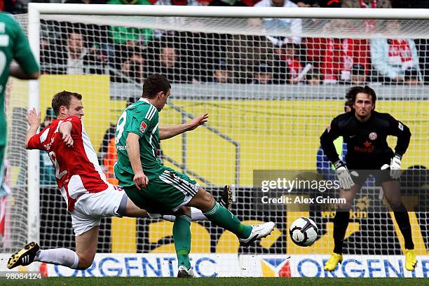 Edin Dzeko of Wolfsburg tries to score against Bo Svensson and goalkeeper Heinz Mueller of Mainz during the Bundesliga match between FSV Mainz 05 and...