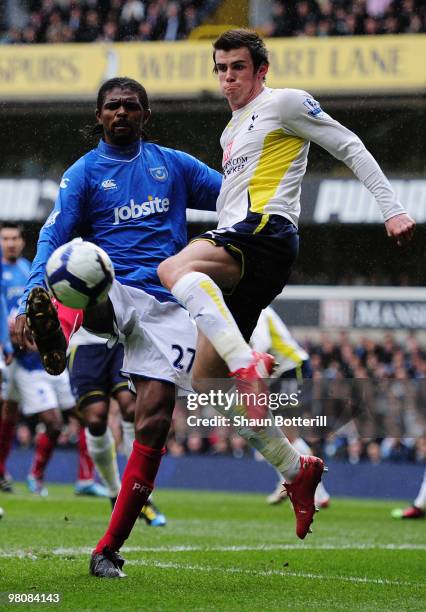 Gareth Bale of Tottenham Hotspur is challenged by Nwankwo Kanu of Portsmouth during the Barclays Premier League match between Tottenham Hotspur and...