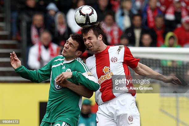 Andreas Ivanschitz jumps for a header with Zvjezdan Misimovic of Wolfsburg during the Bundesliga match between FSV Mainz 05 and VfL Wolfsburg at the...