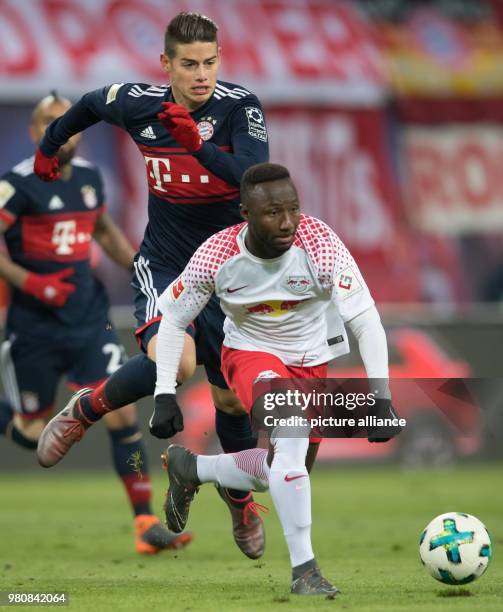 Munich's James Rodriguez vies for the ball with Leipzig's Naby Keita during the German Bundesliga soccer match between RB Leipzig and Bayern Munich...