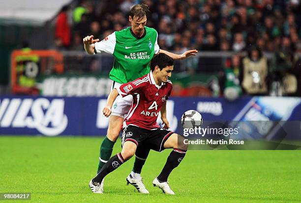 Tim Borowski of Bremen and Ilkay Guendogan of Nuernberg compete for the ball during the Bundesliga match between Werder Bremen and 1. FC Nuernberg at...