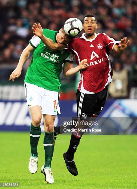 Sebastian Proedl of Bremen and Eric Maxim Choupo Moting of Nuernberg jump for a header during the Bundesliga match between Werder Bremen and 1. FC...