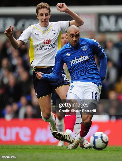 Michael Dawson of Tottenham Hotspur challenges Anthony Vanden Borre of Portsmouth as he takes a shot during the Barclays Premier League match between...