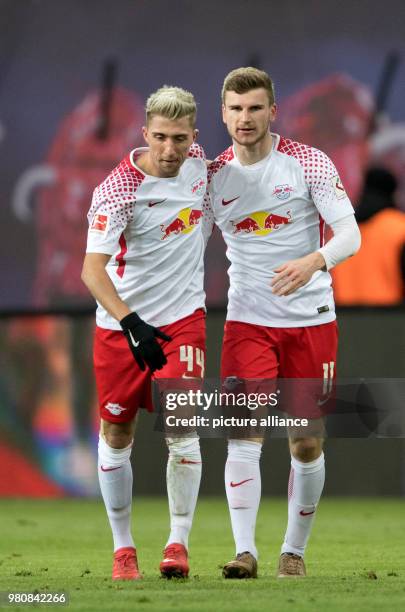 March 2018, Germany, Leipzig: Soccer, Bundesliga, 1. RB Leipzig vs Bayern Munich at the Red Bull Arena. Leipzig's goalscorer Timo Werner and Kevein...