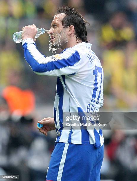 Theofanis Gekas of Berlin refreshes himself during the Bundesliga match between Hertha BSC Berlin and Borussia Dortmund at Olympic Stadium on March...