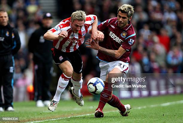 Liam Lawrence of Stoke battles for the ball with Valon Behrami of West Ham during the Barclays Premier League match between West Ham United and Stoke...