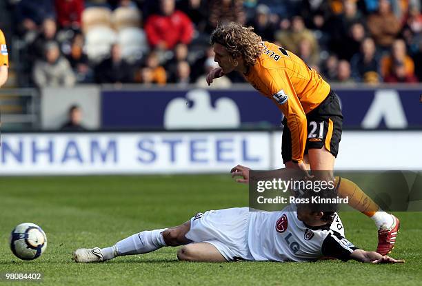 Jimmy Bullard of Hull is challenged by Simon Davies of Fulham during the Barclays Premier League match between Hull City and Fulham at the KC Stadium...