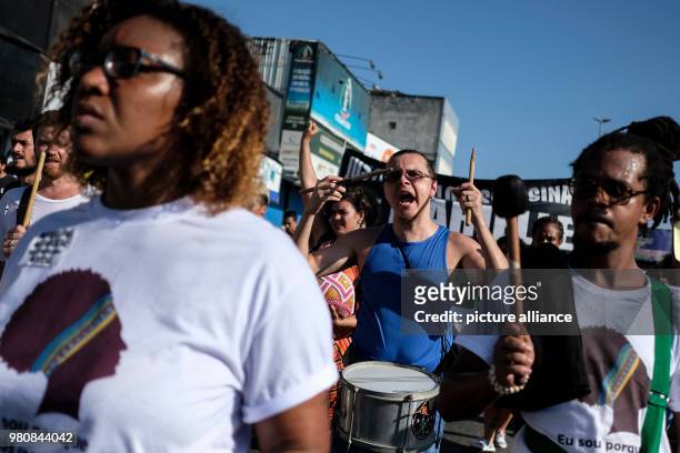 People play their drums during a demonstration in remembrance of Brazilian politician Marielle Franco who was assassinated on Wednesday, in Rio de...