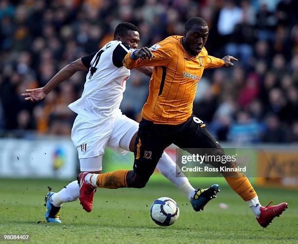Jozy Altidore of Hull is fouled by Kagisho Dikgacoi of Fulham during the Barclays Premier League match between Hull City and Fulham at the KC Stadium...