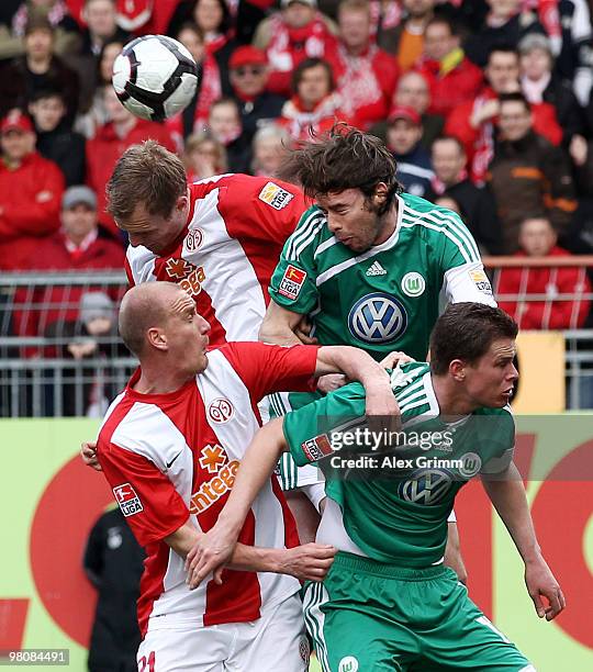 Bo Svensson , Miroslav Karhan of Mainz jump for a header with Andrea Barzagli and Alexander Madlung of Wolfsburg during the Bundesliga match between...