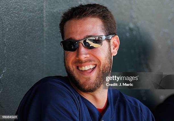 Outfielder Jeremy Hermida of the Boston Red Sox shares a laugh in the dugout as they prepare to play the Baltimore Orioles during a Grapefruit League...