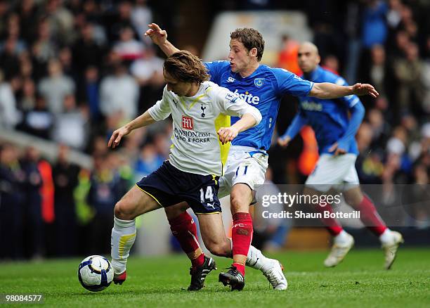 Luka Modric of Tottenham Hotspur is challenged by Michael Brown of Portsmouth during the Barclays Premier League match between Tottenham Hotspur and...