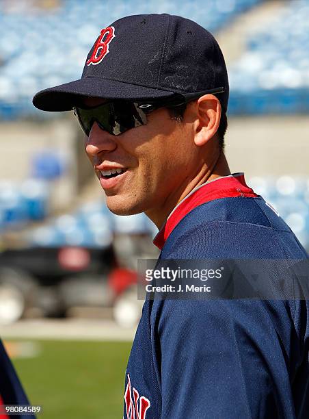 Outfielder Jacoby Ellsbury of the Boston Red Sox talks with a coach before batting practice as they prepare to play the Baltimore Orioles during a...