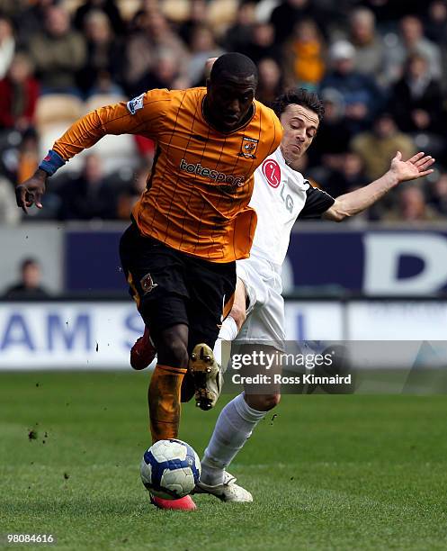 Jozy Altidore of Hull is challenged by Simon Davies of Fulham during the Barclays Premier League match between Hull City and Fulham at the KC Stadium...