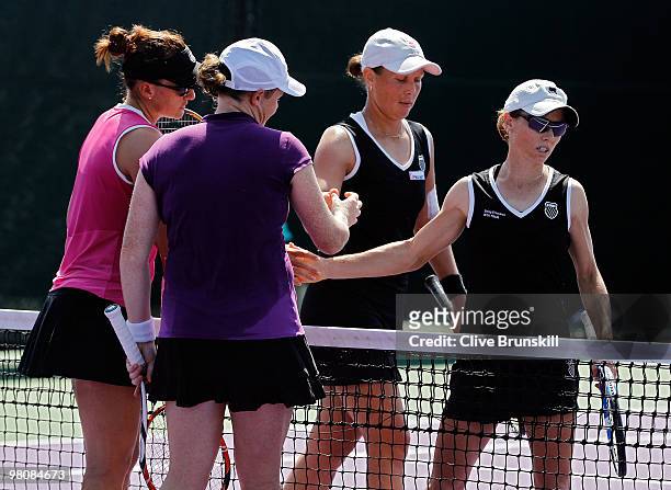 Natalie Grandin and Abigail Spears greet Cara Black and Liezel Huber after their match during day five of the 2010 Sony Ericsson Open at Crandon Park...