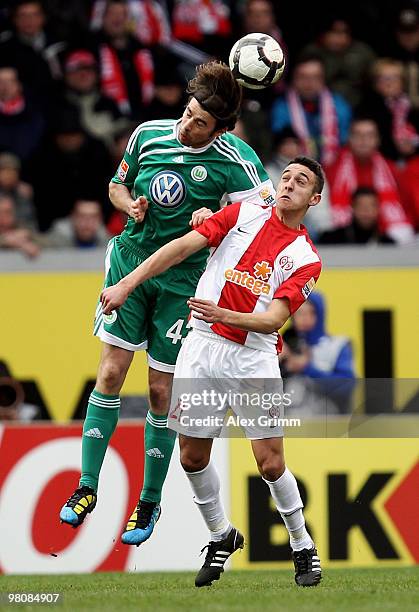 Andrea Barzagli of Wolfsburg jumps for a header with Chadli Amri of Mainz during the Bundesliga match between FSV Mainz 05 and VfL Wolfsburg at the...