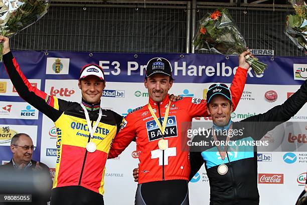 Second Belgian Tom Boonen of Quick-Step, winner Swiss Fabian Cancellara of Saxo Bank and third, Spanish Juan Antonio Flecha, celebrate on the podium...