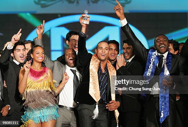 Kamal Orlando Ibrahim of Ireland delight after winning the Mr World 2010 with third runner-up Kenneth Okolie of Nigeria and singer Alesha Dixon...