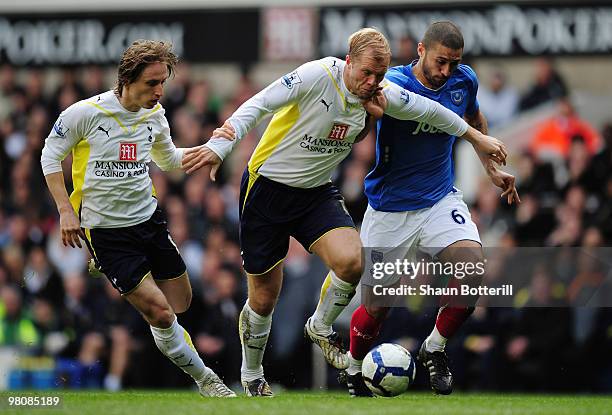 Eidur Gudjohnsen of Tottenham Hotspur is challenged by Hayden Mullins of Portsmouth during the Barclays Premier League match between Tottenham...