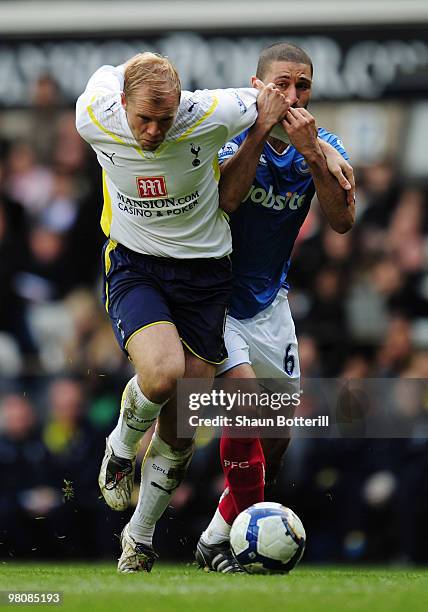 Eidur Gudjohnsen of Tottenham Hotspur is challenged by Hayden Mullins of Portsmouth during the Barclays Premier League match between Tottenham...