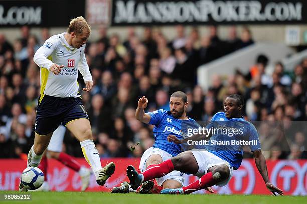 Eidur Gudjohnsen of Tottenham Hotspur is challenged by Hayden Mullins and Aaron Mokoena of Portsmouth during the Barclays Premier League match...